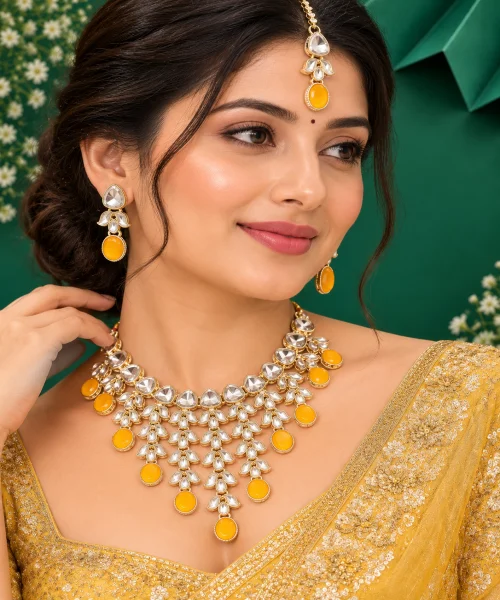 Elegant yellow and golden artificial jewellery set featuring a statement necklace with sparkling white stones, rich yellow oval stones, and intricate floral detailing.